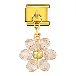 Close-up of a sparkling crystal flower pendant attached to a gold Italian charm link