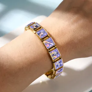 Close-up view of golden Italian modular bracelet with purple graduation enamel charms on wrist