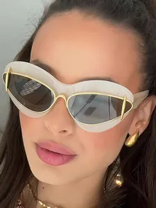 Close-up view of stylish women's cat-eye sunglasses with white frames and gold accents