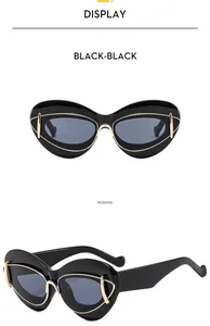 Front and side views of stylish black cat-eye sunglasses with gold metal accents.