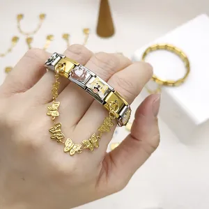 Close-up of gold and silver Italian modular charm bracelet with butterfly safety chain