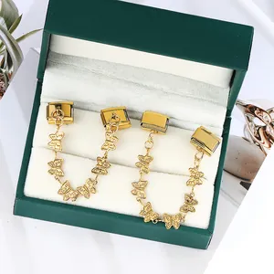 Detailed view of gold butterfly Italian modular charms in a green gift box.