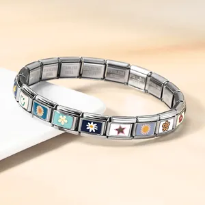 Detail of Italian modular stainless steel bracelet with colorful floral and smiley charms