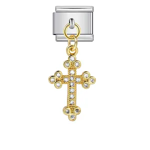 Detailed view of a gold cross pendant charm set with stones for modular link bracelets.
