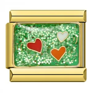 Close-up of gold stainless steel Italian charm with three hearts on green glitter