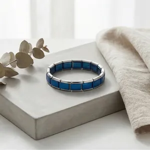Detailed macro view of a blue and silver stainless steel modular Italian charm bracelet