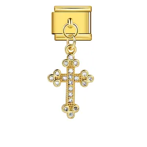 Macro view of a golden stainless steel cross charm for Italian modular bracelet links