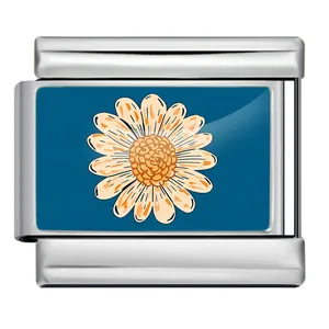 Detailed macro view of a stainless steel Italian charm link with orange daisy pattern.