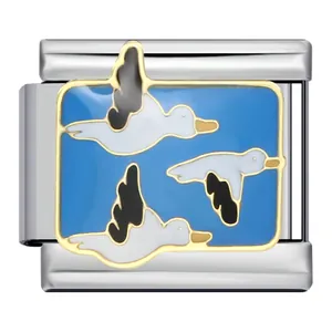 Détail du motif émaillé de canards volants sur un charm de bracelet modulaire en inox