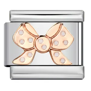 Detail of stainless steel Italian charm link featuring a rose gold polka dot bow