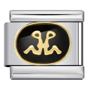 Macro detail of Italian charm link with gold zodiac sign on black enamel background