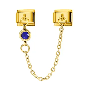 Detailed view of the gold Italian charm link featuring a blue birthstone and safety chain