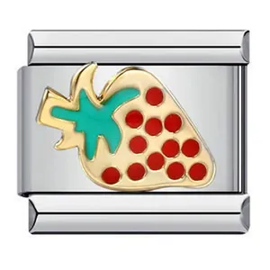 Macro view of a stainless steel Italian modular link featuring an enamel strawberry charm.