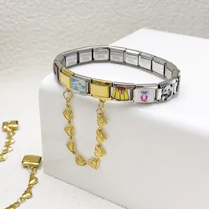 Close-up of Italian modular charm bracelet with heart chain and cute icons.