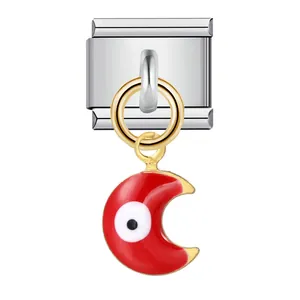 Close-up of red crescent moon Evil Eye charm on stainless steel Italian bracelet link