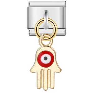 Detail view of a stainless steel Italian modular charm with a red Hamsa hand pendant