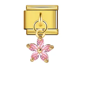 Detail view of a premium gold Italian charm featuring a pink crystal flower pendant