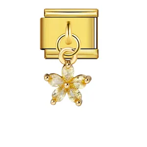 Close-up of gold stainless steel Italian charm link with yellow gemstone flower dangle