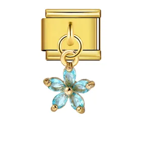 Elegant gold Italian modular bracelet charm with a blue gemstone flower pendant detail