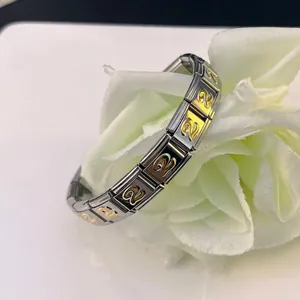 Close-up of Italian modular charm bracelet with gold-plated number 2 detail