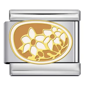 Detailed view of a vintage style Italian charm with gold floral pattern and beige enamel.