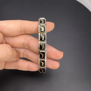 Close-up detail of Italian charm bracelet with Florida map pattern on black modules