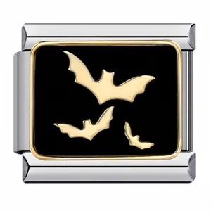 Macro detail of a modular Italian charm link with golden bat motifs on black enamel
