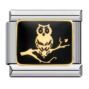 Detailed macro view of a gold-tone owl on a branch Italian charm link for bracelet