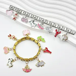 Close-up of modular charm bracelets with cute enamel animal pendants in gold and silver.