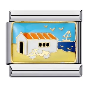 Detail of Italian charm link featuring a beach house and sailboat enamel design