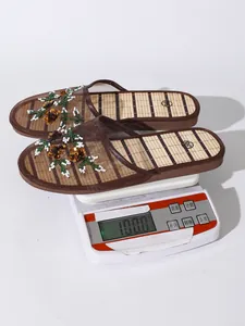 Detail of embroidered mesh mule slippers weighing 100g on a digital kitchen scale