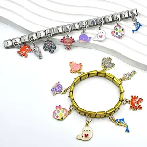 Detail view of Italian charm bracelet with glittery sea animal charms like crab and dolphin