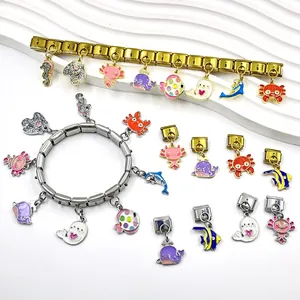 Detailed view of diverse ocean animal charms on gold and silver Italian link bracelets
