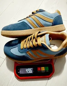 Close-up of retro color-block sneakers on a digital scale showing product weight