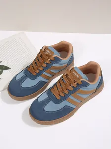 Top view of retro blue and brown contrast color women's GAT sneakers on white base