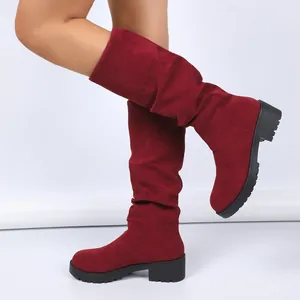 Slouchy wine red suede mid-calf boots with a comfortable low block heel and lug sole.