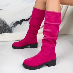 Fuchsia suede slouchy mid-calf boots featuring low block heel and black rubber sole