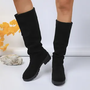 Elegant black suede mid-calf slouchy boots featuring a pleated design and stable low heel