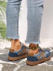 Close-up of retro color-blocking German trainer sneakers with brown gum sole details