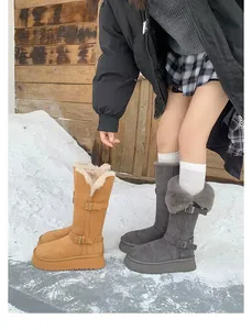 Stylish platform tall snow boots with warm faux-fur lining in a snowy outdoor scene