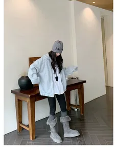 Full body view of women's tall grey snow boots with faux fur trim and thick platform soles