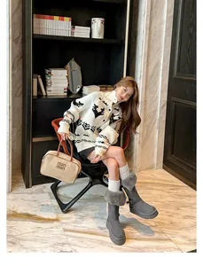 Elegant woman wearing grey tall snow boots with fur trim and height-increasing thick soles
