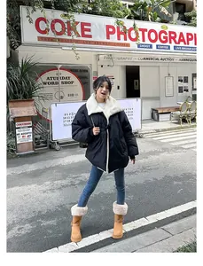 Stylish model wearing tall khaki platform snow boots with warm fur lining outdoors