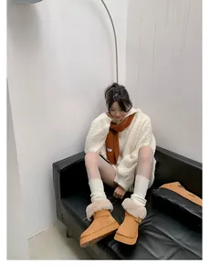 Cozy platform snow boots with fur trim shown in a stylish winter outfit scene.