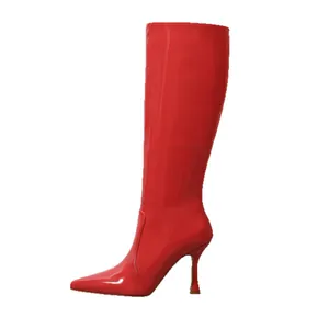 Elegant red pointed-toe knee-high boots with slim high heels in shiny patent leather