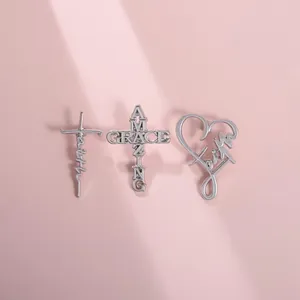 Detailed view of silver punk style brooches featuring Faith and Amazing Grace motifs