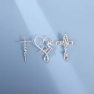 Detailed view of silver punk style pins featuring faith heart and cross designs with slogans