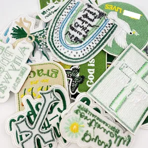 Detailed collection of green embroidered patches with inspirational English quotes.