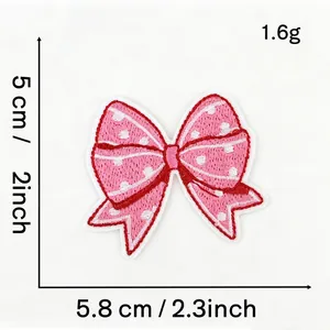 Detail view of pink polka dot bow embroidery patch showing dimensions 5.8cm by 5cm
