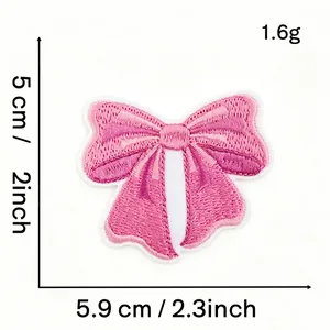 Close-up detail of a pink bow embroidery patch showing exact dimensions 5.9 x 5 cm